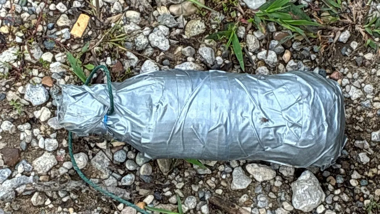Police tape and a bomb squad response near a roadside investigation in Paw Paw, Michigan