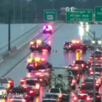 Police and traffic response at a closed highway overpass after a truck crash