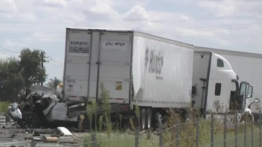 Closed highway lanes near a fatal crash scene with emergency vehicles and traffic blocked